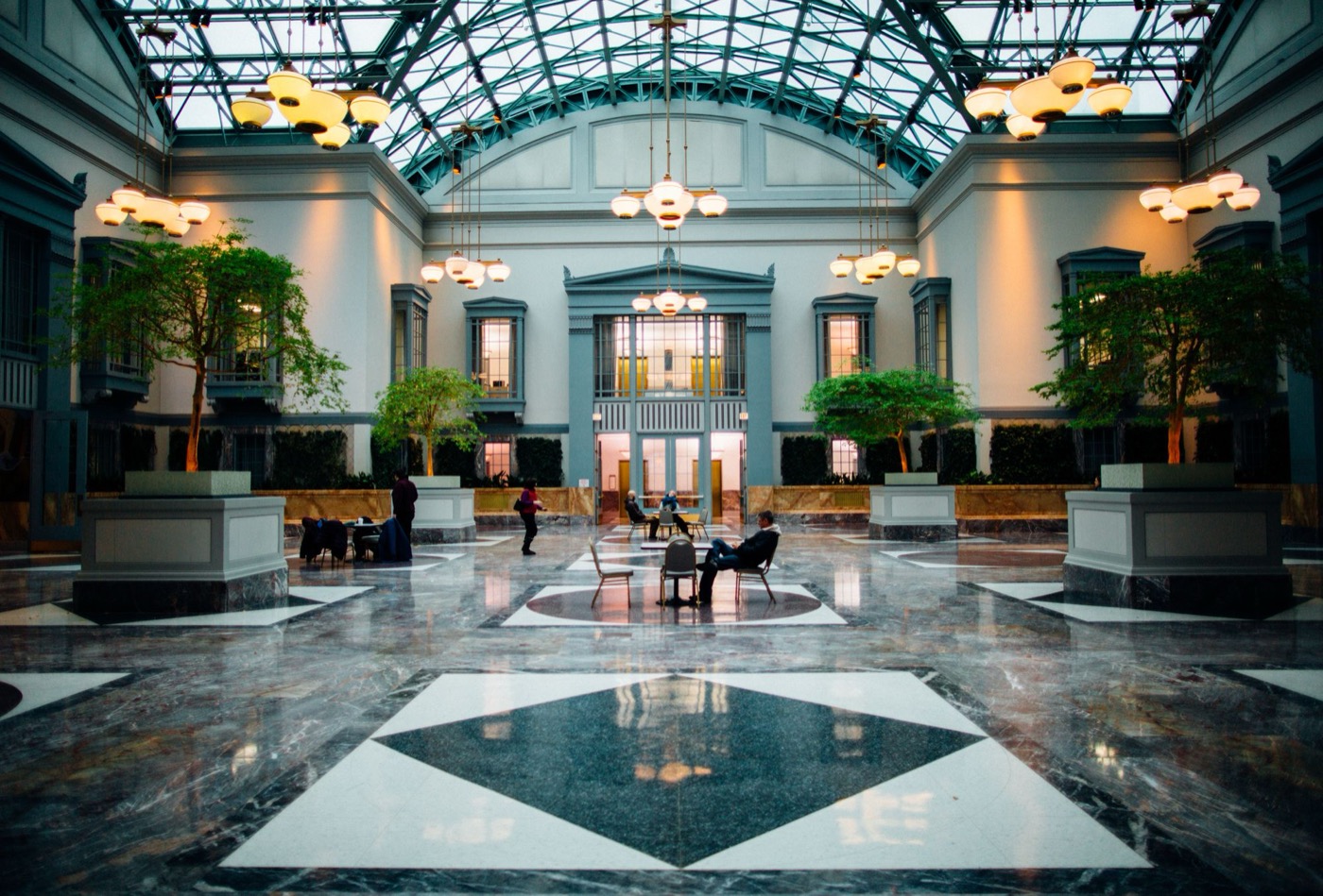 Grand hotel lobby with glass atrium and marble floor