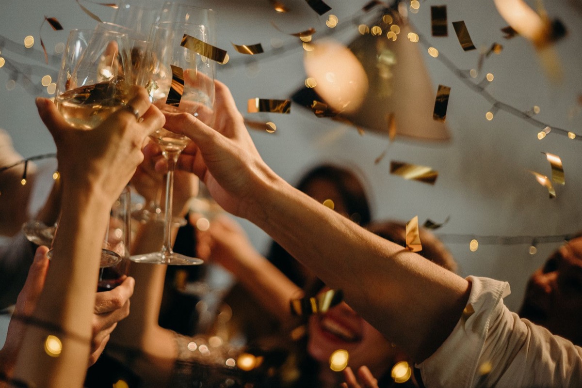 Celebration toast with champagne and confetti